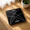 ZIPSON black digital body weight scale placed on a wooden floor for home use